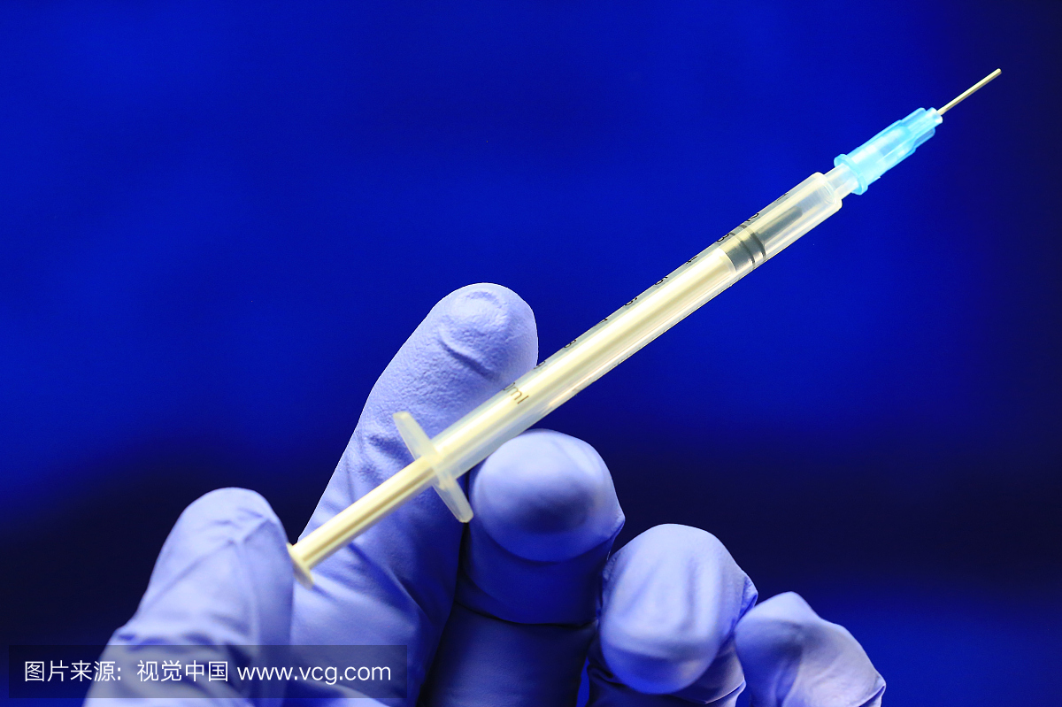 Health worker prepares a Hypodermic needle a