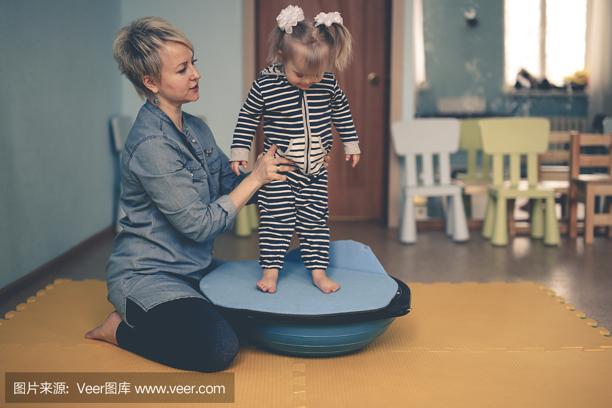 woman is engaged with child on balancer beam