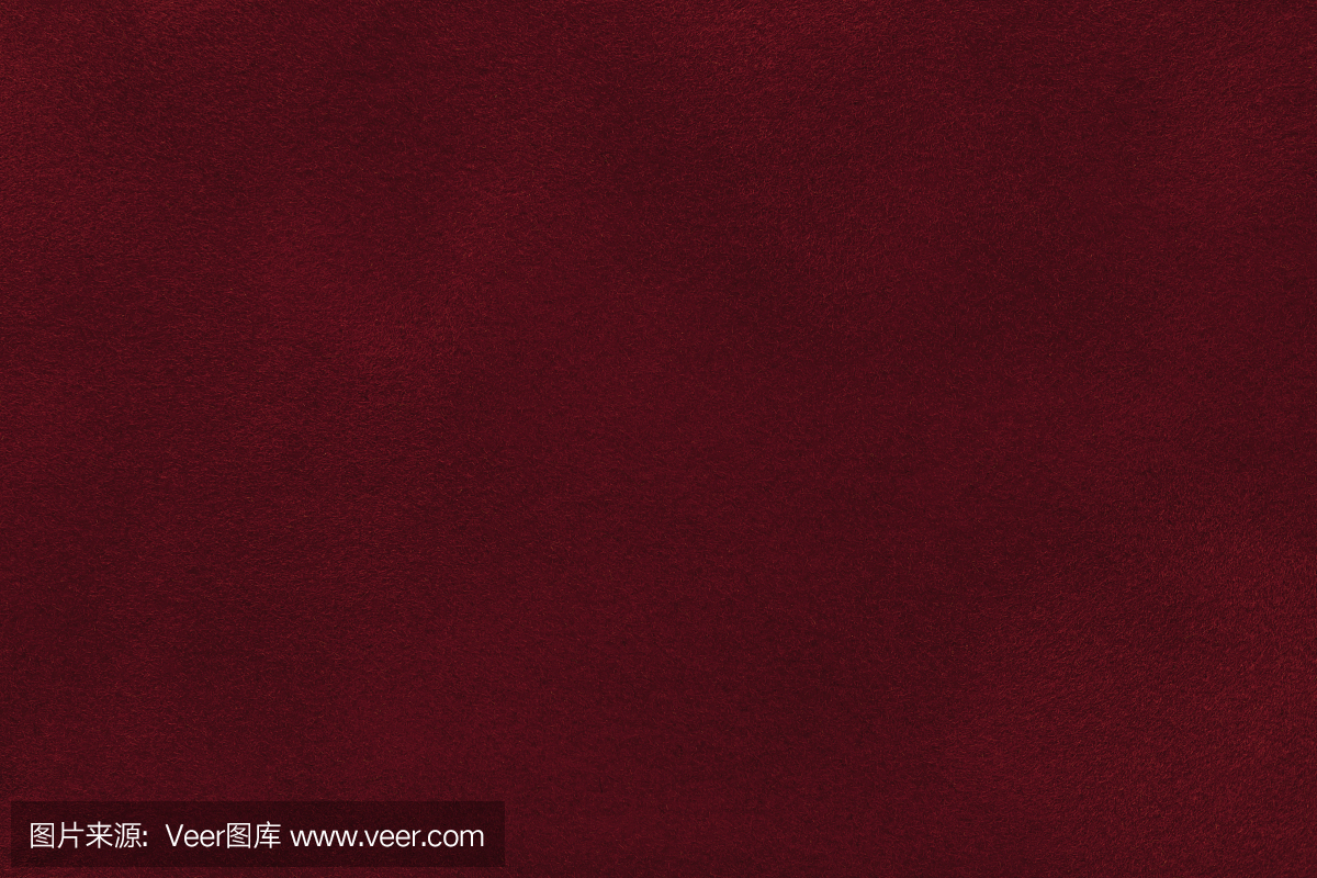 暗红色绒面革织物特写的背景。天鹅绒亚光质地的酒磨砂纺织品