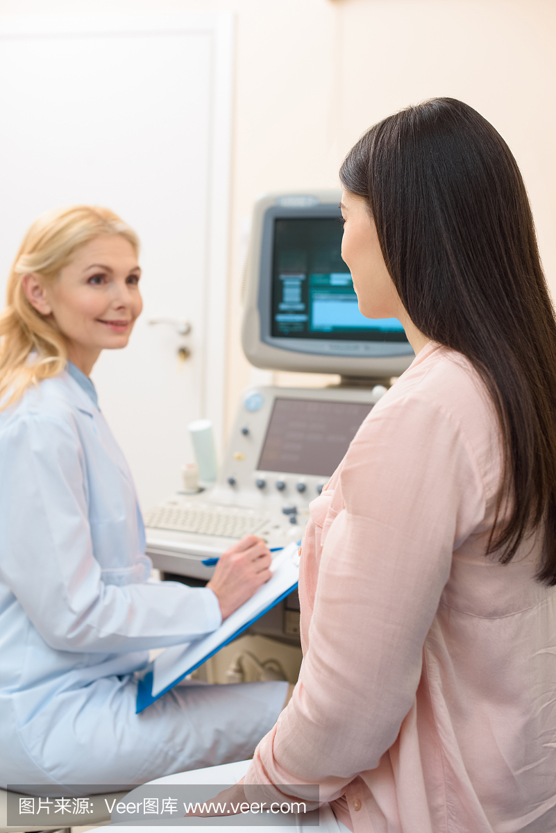 妇产科医师咨询孕妇在超声波扫描办公室