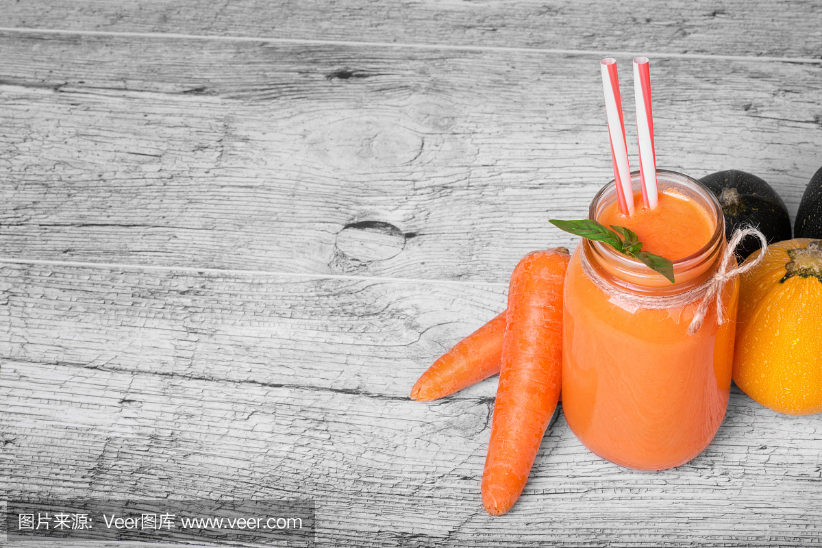 胡萝卜汁的梅森罐子。多彩的思慕雪,生蔬菜在