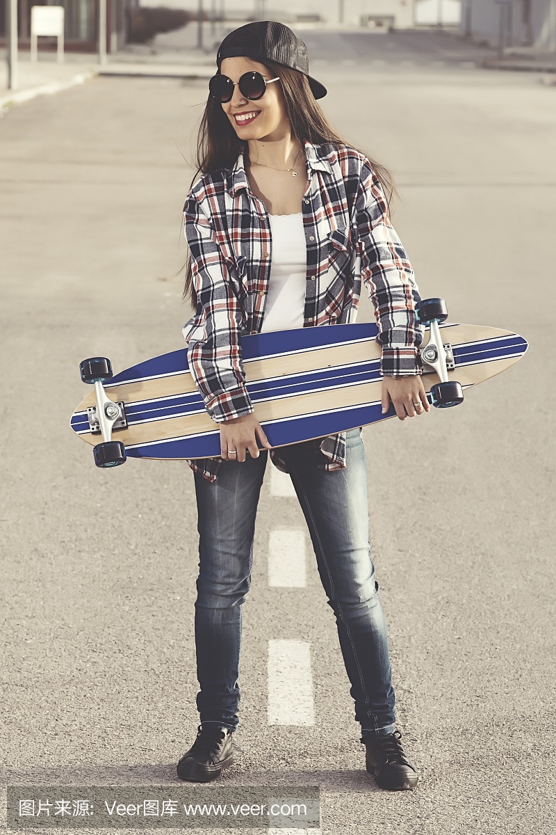 西班牙,在路上摆姿势与滑板的溜冰者女性的镜