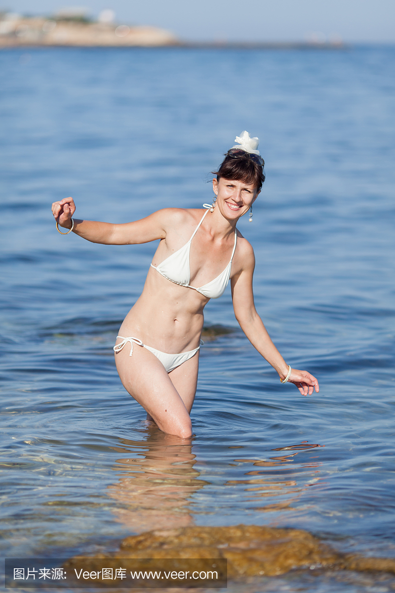 Portrait of happy woman at the sea