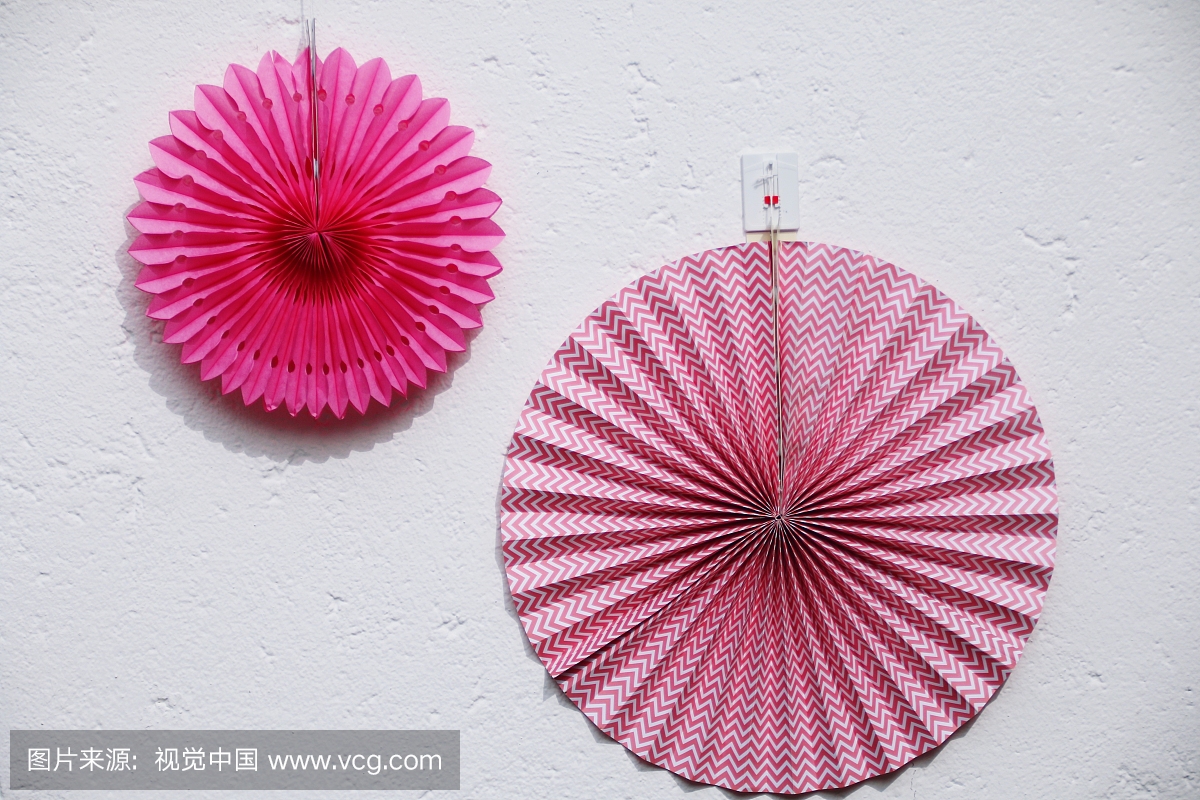 Close-Up Of Hand Fans Hanging On Wall