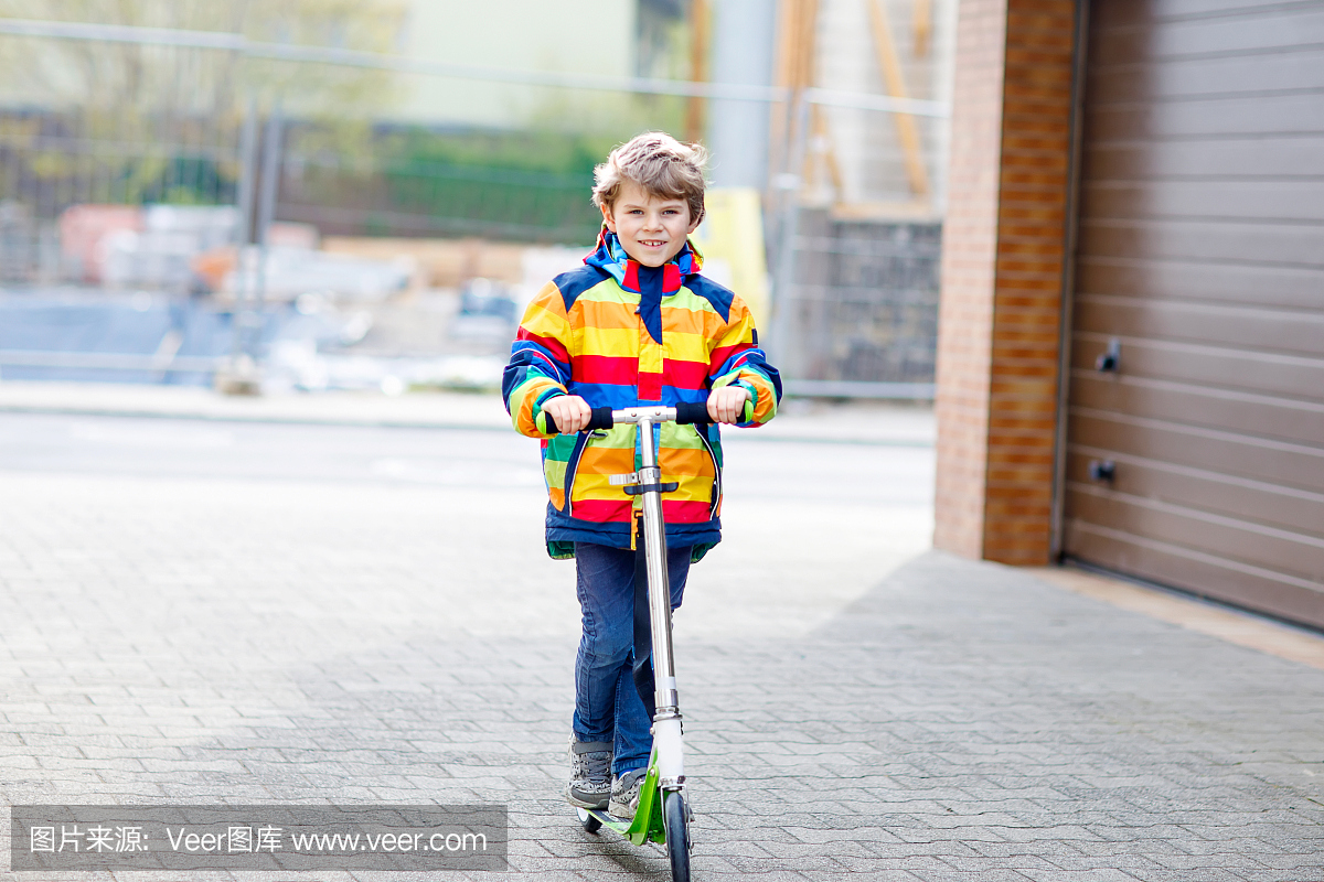 活跃的学校孩子男孩在五颜六色的休闲服装骑着