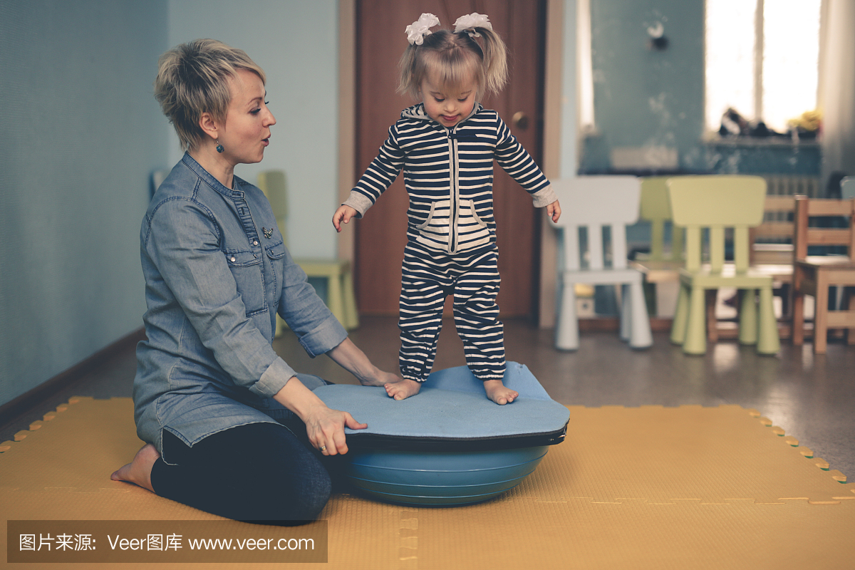 woman is engaged with child on balancer beam
