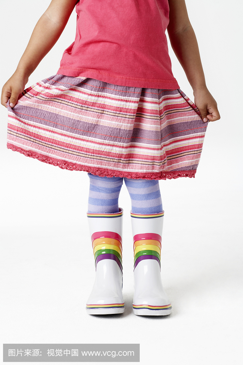 Girl Holding Skirt and Wearing Rainbow Galosh