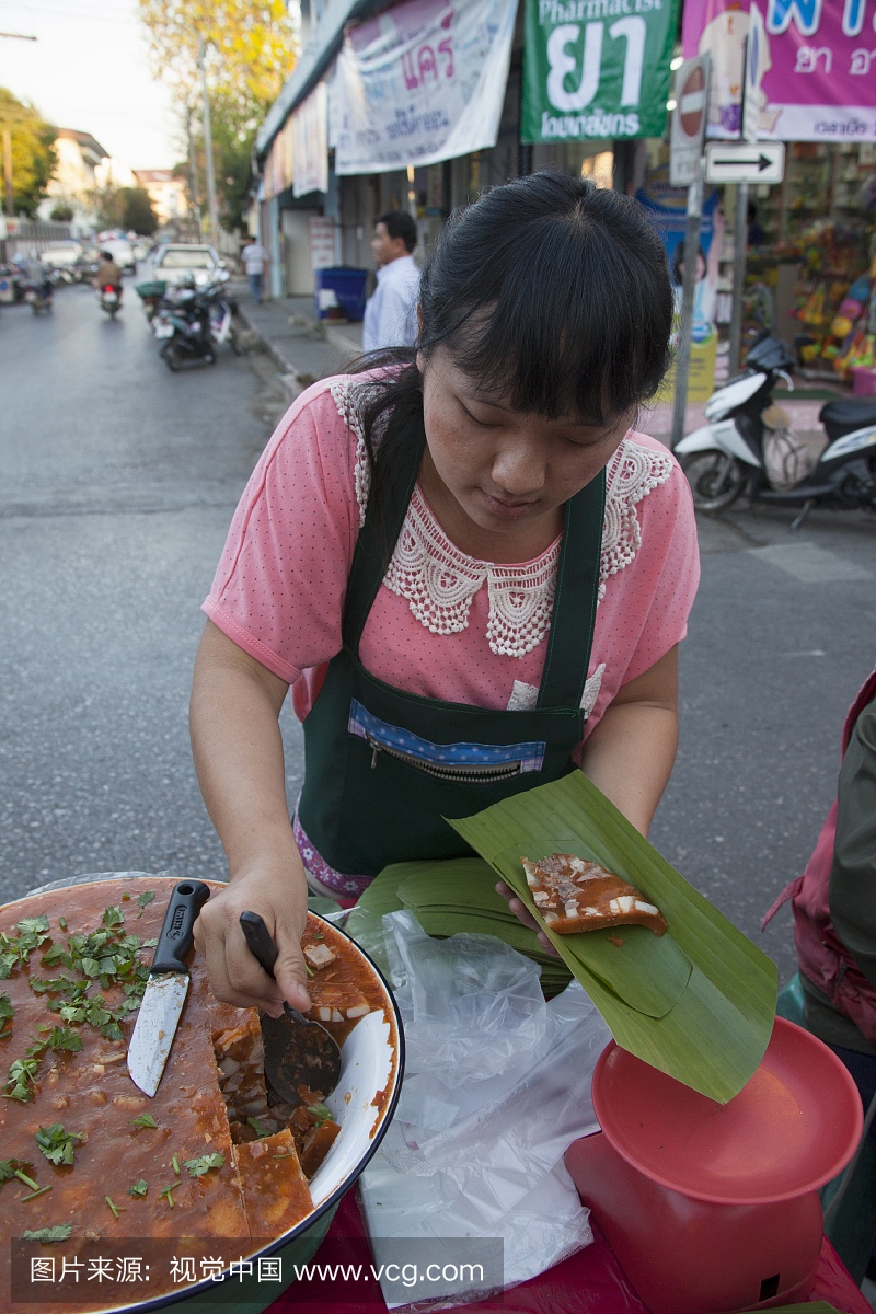A woman selling Northern Pork Curry, Thailand