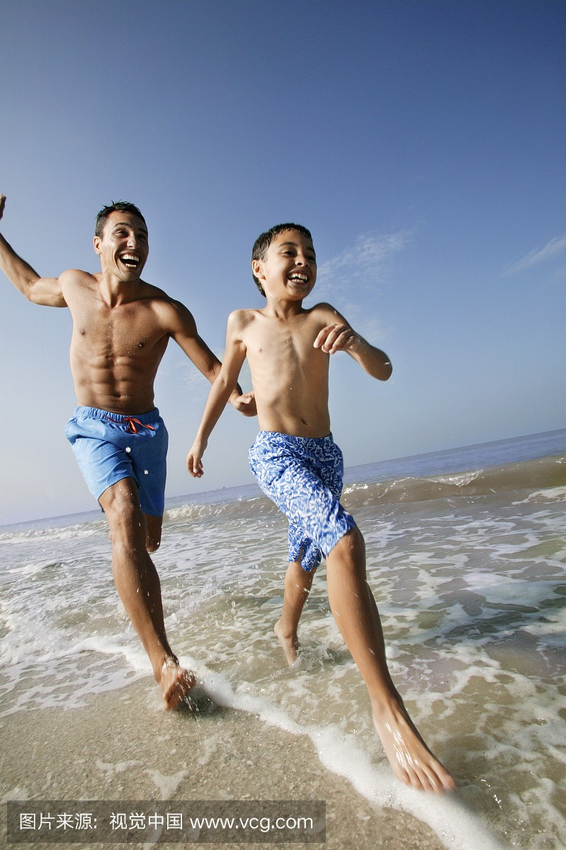 Father and Son Running on Beach
