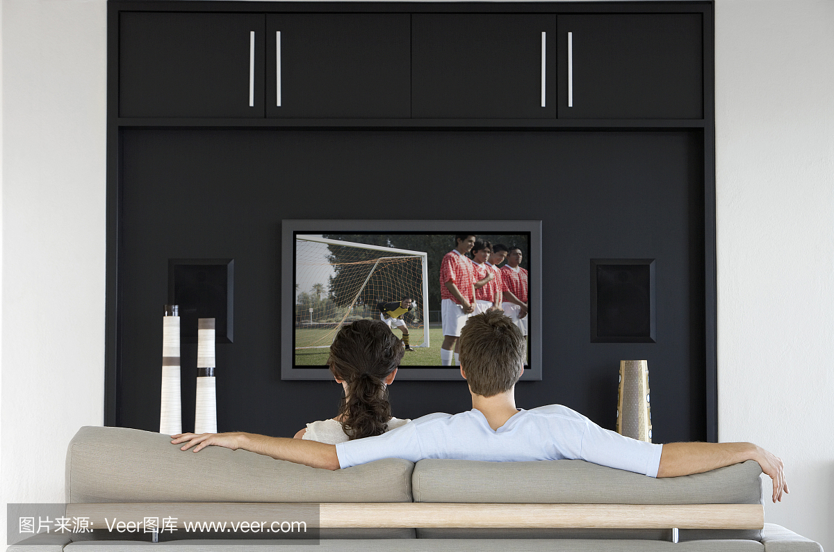 夫妇在电视上看足球比赛