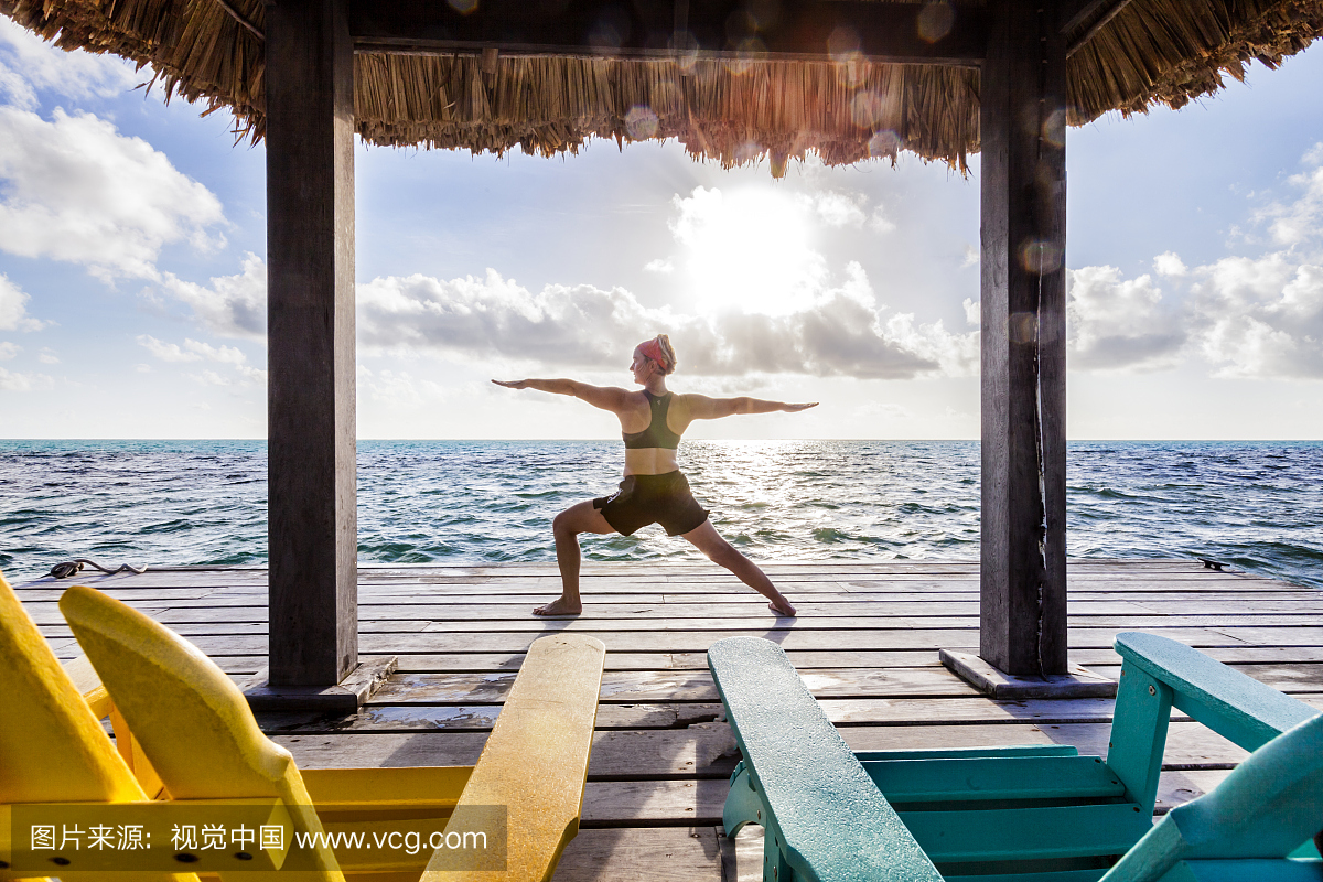 A woman on vacation in Belize, doing yoga pos