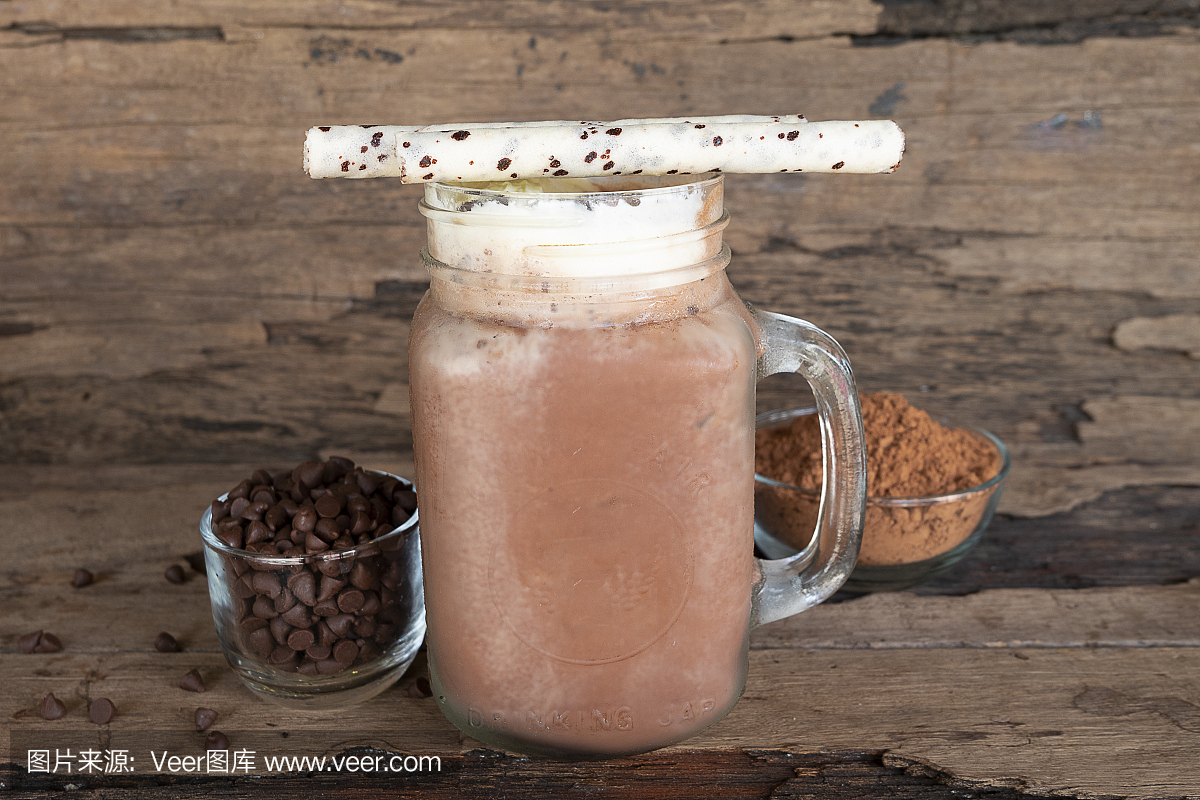 巧克力和可可粉混合牛奶冰沙在木地板上。