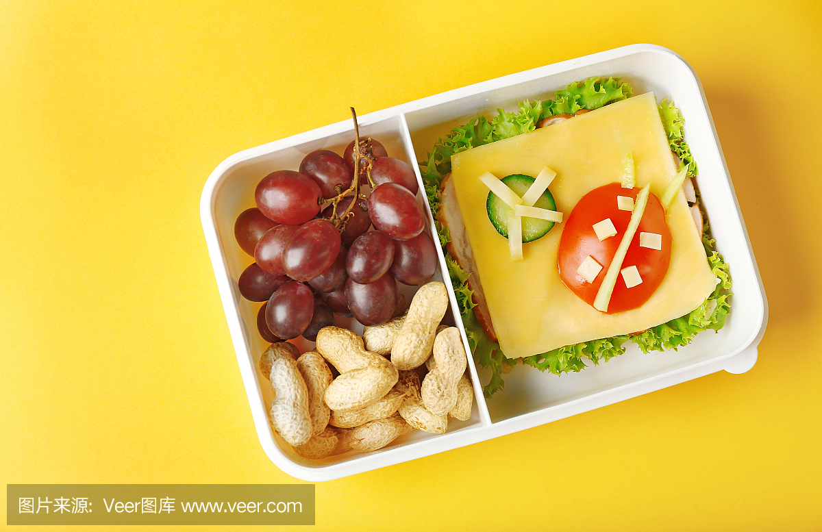 Lunchbox with dinner on yellow background