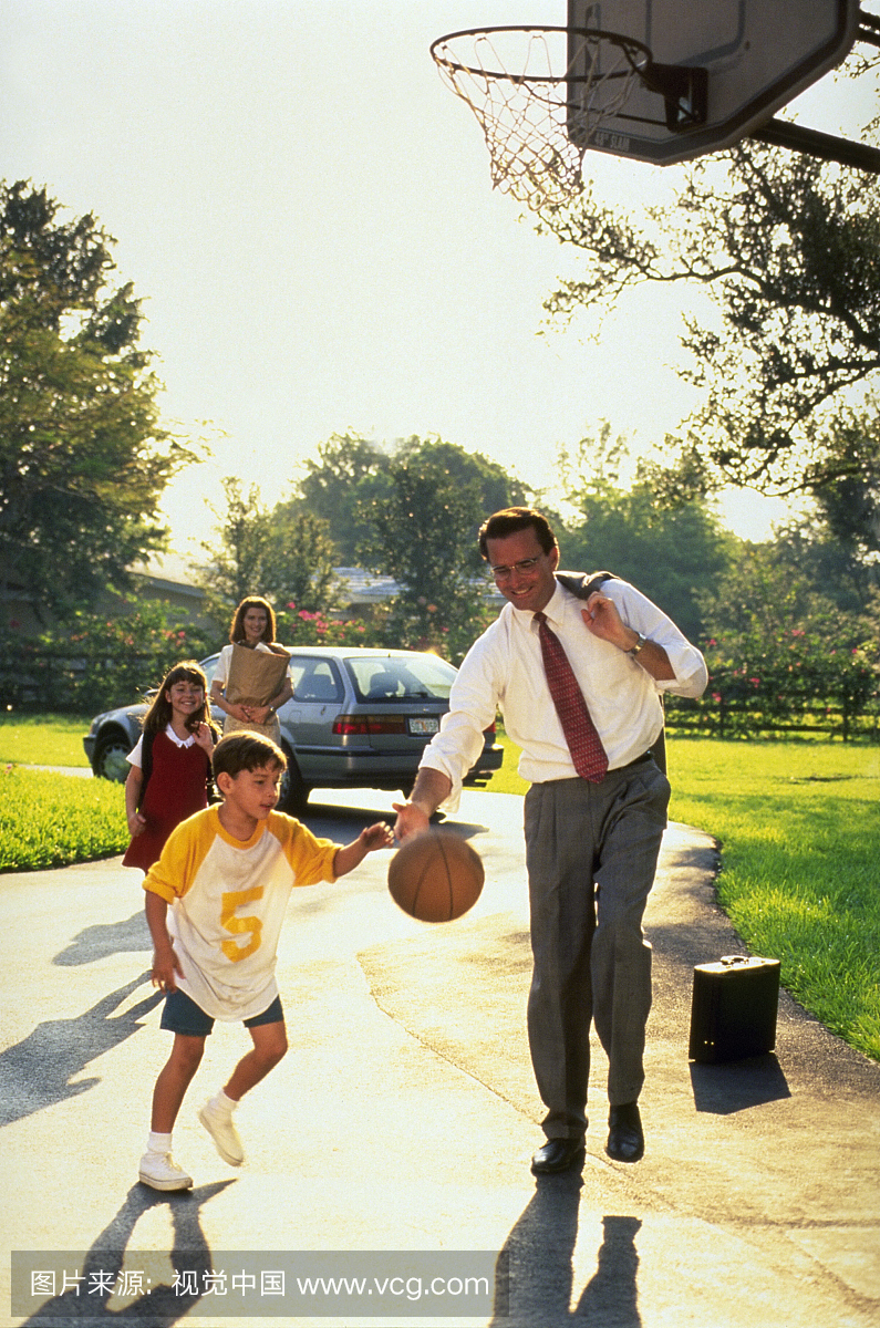 Executive playing hoop with his son